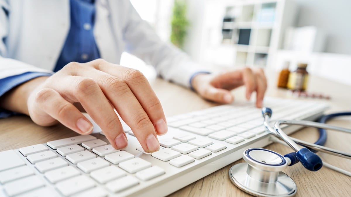 Female doctor typing on computer