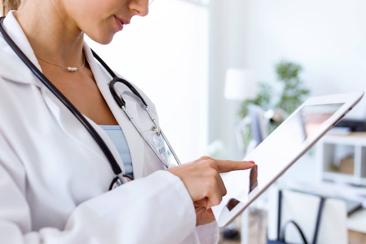 Female doctor using her digital tablet in the office.