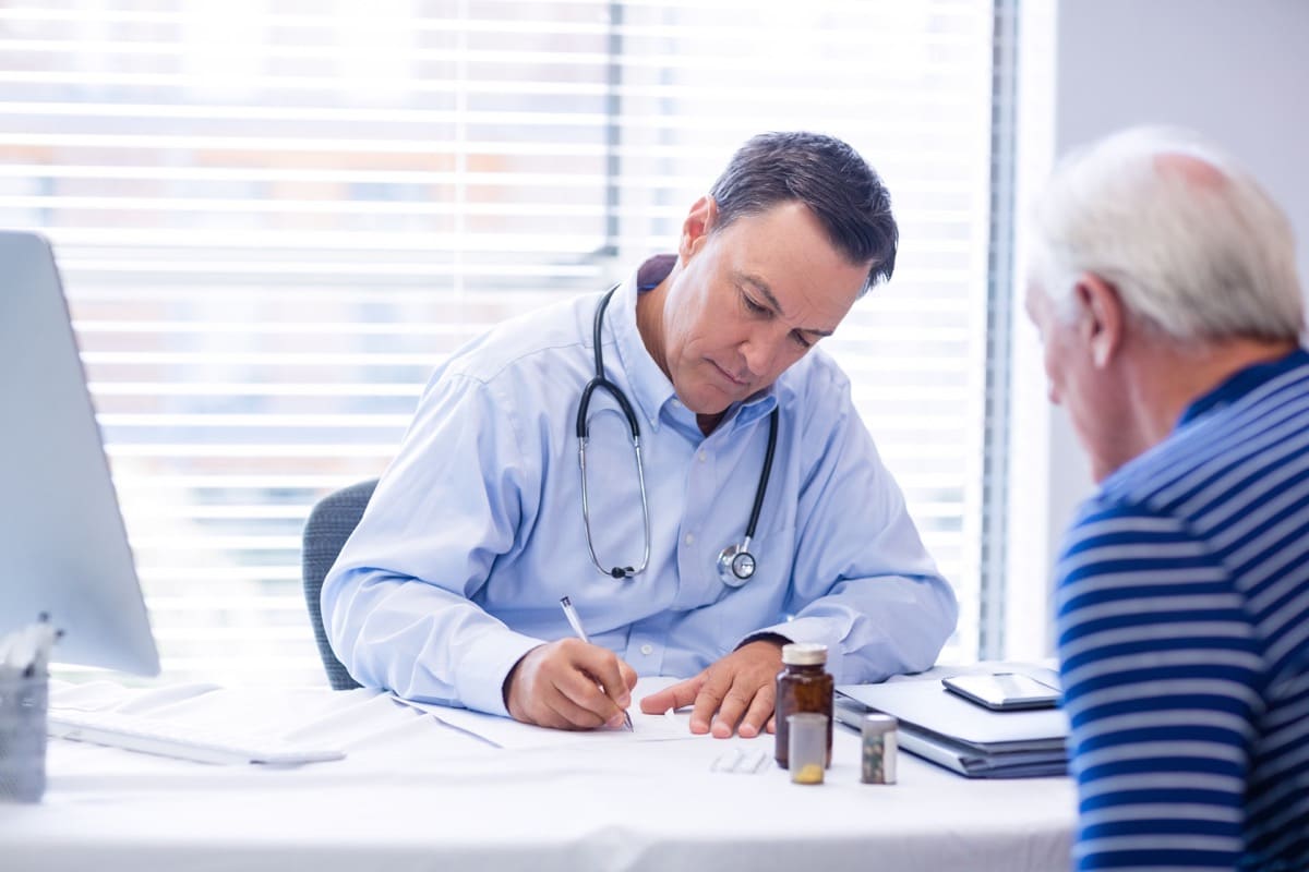 Doctor prescribing medicine to senior patient